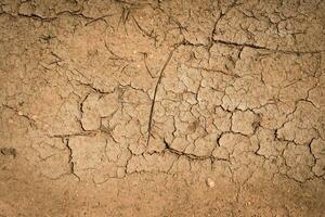 Crack soil dry season on sand background. photo