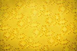 Yellow lace fabric background texture. photo