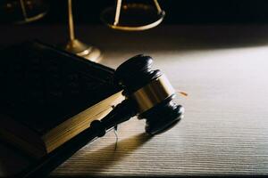 Business and lawyers discussing contract papers with brass scale on desk in office. Law, legal services, advice, justice and law concept picture with film grain effect photo