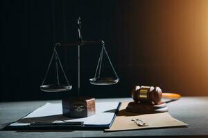 law legal technology concept. judge gavel on computer with scales of justice on desk of lawyer. photo