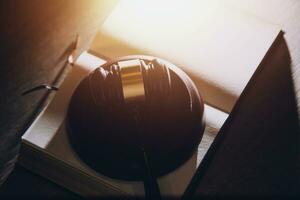 Business and lawyers discussing contract papers with brass scale on desk in office. Law, legal services, advice, justice and law concept picture with film grain effect photo