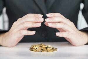 Close up business hands save money to stack of coins. photo