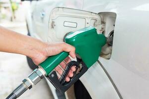 Man fill up fuel at a gas station. photo