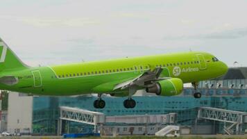 NOVOSIBIRSK, RUSSIAN FEDERATION JULY 15, 2022 - Airbus A320 214, RA 73407 of S7 Airlines landing, touchdown and braking, side view. Tourism and travel concept video