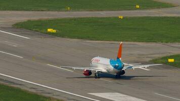 SOCHI, RUSSIA AUGUST 04, 2022 - Sukhoi Superjet 100 of Azimuth on runway before take off at Sochi airport, rear view. Azimuth Russian airline. Tourism and travel concept video