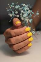 Yellow manicure. Square nails with gel polish. Sunny and bright manicure photo