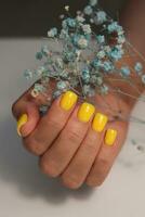 Yellow manicure. Square nails with gel polish. Sunny and bright manicure photo