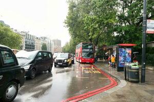 Low Angle View of Busy Central London City and Road with Traffic During Rain and Cloudy Day over England Great Britain of UK. Image Was Captured on August 2nd, 2023 photo