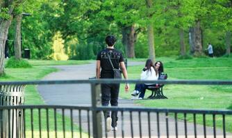 Beautiful Low Angle View of People are Enjoying the Starting of Summer at Wardown Public Park of Luton Town of England UK. The Footage Was Captured on Beautiful Day of April 22rd, 2023 photo