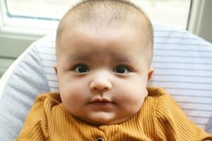 Close Up Shot of Cute Asian Pakistani 4 Months Old Baby Boy, Who is Enjoying at Home Garden at Luton City of England UK. Image Was Captured on July 23rd, 2023 photo