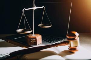 law legal technology concept. judge gavel on computer with scales of justice on desk of lawyer. photo