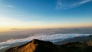 The beautiful Landscape view from Lawu Mountain at sunrise located in Magetan. One of the most beautiful mountains in Java with an altitude of 3265m above sea level. Magetan, Indonesia August 1, 2023 photo