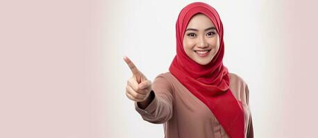 Asian Muslim woman pointing fingers isolated on white background celebrating Indonesian independence day on 17 August photo