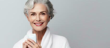 Elderly lady holding chapstick and smiling photo