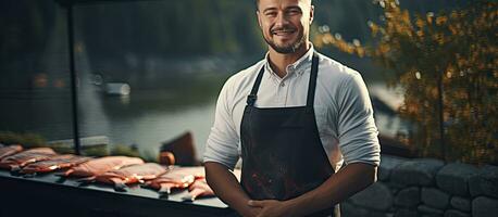 Man grilling salmon fish outdoors empty area Man barbecuing salmon in apron photo