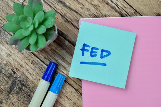 Concept of FED write on sticky notes isolated on Wooden Table. photo