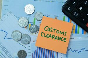Concept of Customs Clearance write on book isolated on Wooden Table. photo