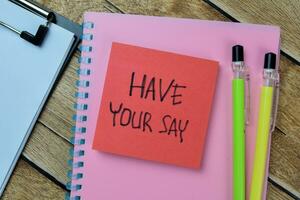 Concept of Have Your Say write on sticky notes isolated on Wooden Table. photo