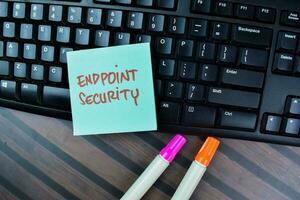 Concept of Endpoint Security write on sticky notes isolated on Wooden Table. photo