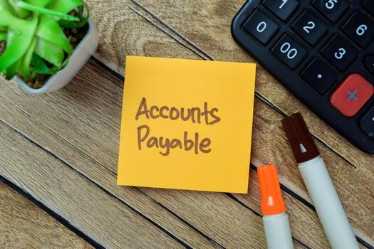 Concept of Accounts Payable write on sticky notes isolated on Wooden Table. photo