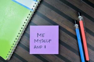 Concept of Me Myself And I write on sticky notes isolated on Wooden Table. photo