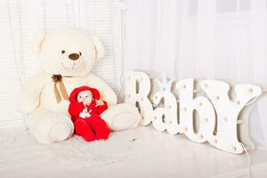 Baby with teddy bear. Christmas holiday concept photo