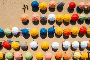 Aerial top view on the beach. Colorful Umbrellas, sand and sea beach, AI generate photo