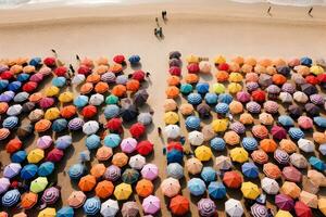 Aerial top view on the beach. Colorful Umbrellas, sand and sea beach, AI generate photo