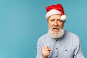 Gloomy Santa Claus portrait against blue background with copy space blue background. Economy crisis and troubles end of year concept photo