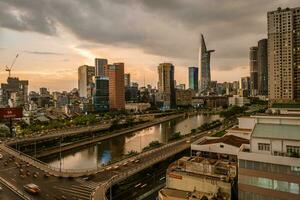 Ho Chi Minh, Viet Nam - 22 June 2023 Aerial view of Bitexco Tower, buildings, roads and Saigon river in Ho Chi Minh city photo