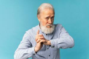 Portrait angry old man white bearded pensioner unhappy mad crazy conflict disagreement over blue color background - negative human emotions face expression feelings photo