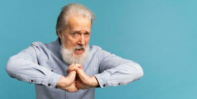 Banner Portrait of angry pissed off bad senior mature man on blue background copy space. Negative human emotions, face expression feelings photo