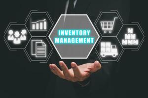 Inventory management concept, Businessman hand holding inventory management icon on virtual screen. photo