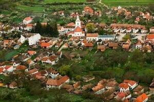 Rimetea is a small village located in Transylvania, Romania. It is situated in the Apuseni Mountains and is known for its picturesque setting and well preserved Hungarian architectural style. photo