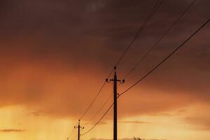 High-voltage power lines at sunset. Electricity distribution station.  electricity pylons on the background of the sky photo