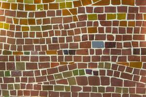 Colorful ceramic mosaic on the walls of the building. Abstract background and texture for design. photo