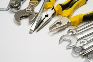 Set of tools for repair in a case on a white background. Assorted work or construction tools. Wrenches, Pliers, screwdriver. Top view photo