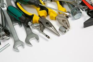 Set of tools for repair in a case on a white background. Assorted work or construction tools. Wrenches, Pliers, screwdriver. Top view photo