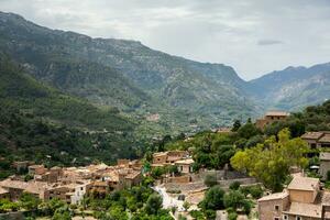 View of a medieval street in the Old Town of the picturesque Spanish-style village Fornalutx, Majorca or Mallorca island photo