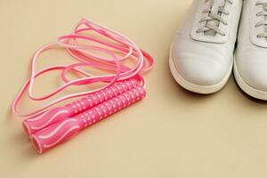 jump rope and sneakers on a light background, weight loss photo