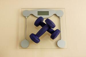 dumbbells on floor scales, weight loss workout at home photo