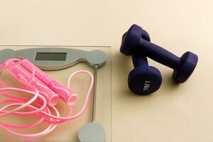 dumbbells, scales and skipping rope, sport at home photo