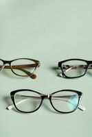 Stylish eyeglasses on colored background. Optical store, vision test, stylish glasses concept. photo