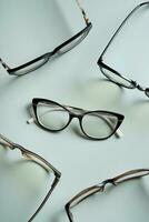 Stylish eyeglasses on colored background. Optical store, vision test, stylish glasses concept. photo