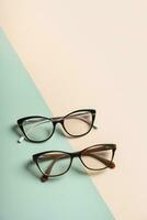 Stylish eyeglasses on colored background. Optical store, vision test, stylish glasses concept. photo