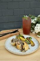 Main course with meat and potatoes and lemonade on a wooden table photo