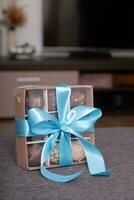 Gift box with chocolate craft candies at home interior. Sweet gift box photo