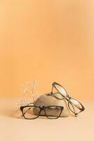 Nature stone with eyeglasses on colored background. Optical store, vision test, stylish glasses concept photo