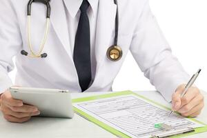 Doctor record history or filling medical form. photo