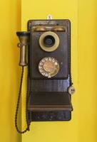 Antique vintage telephone yellow grunge background. photo